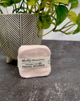 Blush Pink Facial Round set propped against a potted plant