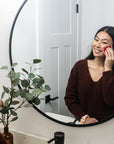 Young lady using a Facial Round to apply toner or remove makeup