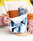 Marley's Monsters UNpaper® Towels + Wooden Holder shows cotton flannel reusable paper towels being pulled like a paper towel.