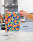 Shows a hand pulling off one UNpaper® Towel in the Marley's Favorites pack in the Oranges print. Marley's Monsters