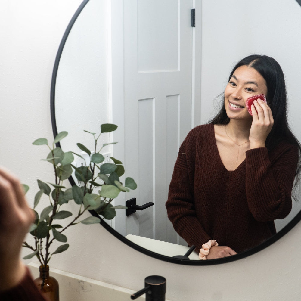 Young lady using a Facial Round to apply toner or remove makeup 