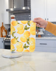 Shows a hand pulling off one UNpaper® Towel in the Marley's Favorites pack in the Vintage Lemons print. Marley's Monsters