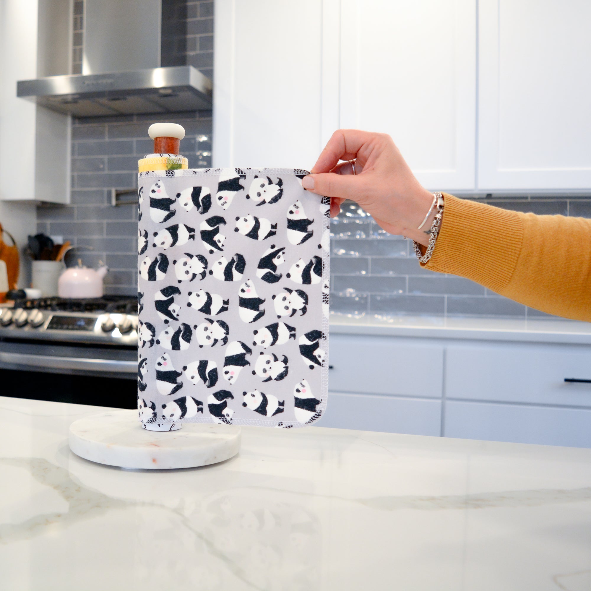 Shows a hand pulling off one UNpaper® Towel in the Marley&#39;s Favorites pack in the Pandas print. Marley&#39;s Monsters